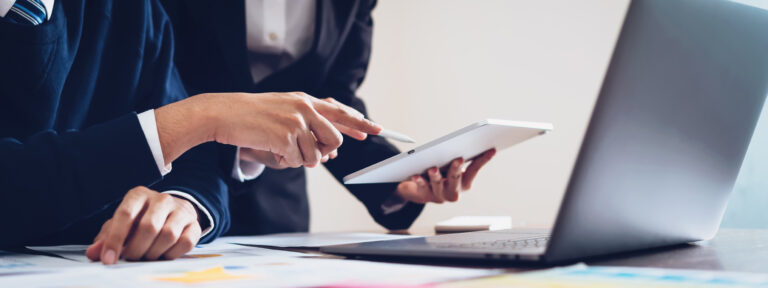 Business team using tablet and laptop computer to work in the office. proportion of the banner for ads